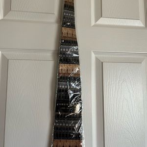 New preowned Giorgio Bissoni men’s silk tie in color black/tan with price tag on